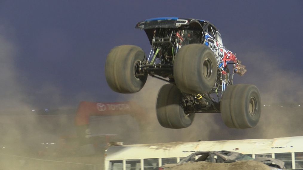 A monster truck jumps over a school bus in the freestyle event.{&nbsp;}{p}{/p}