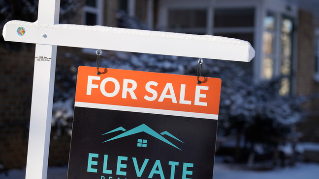 A for sale sign appears outside a condominium complex Monday, Jan. 15, 2024, in Denver. (AP Photo/David Zalubowski)