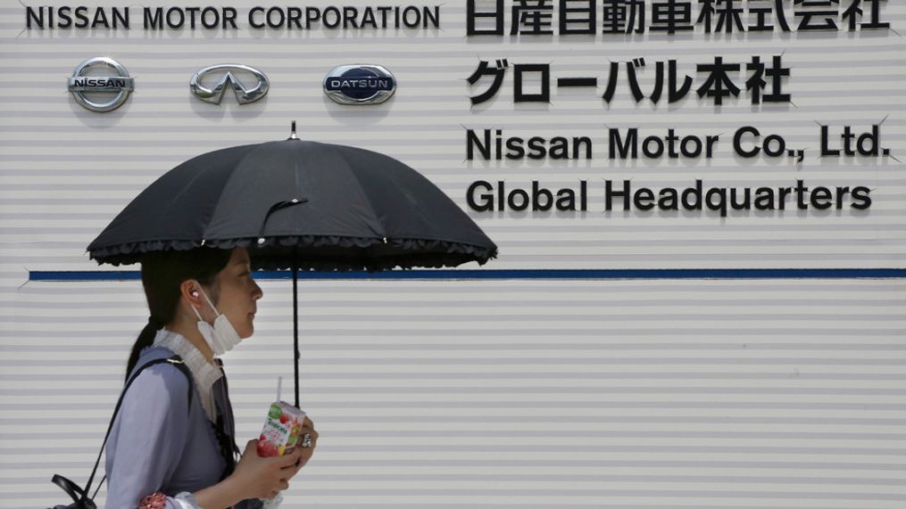 A woman walks past the global headquarters of Nissan Motor Co., Ltd. in Yokohama near Tokyo, Wednesday, May 27, 2020.{&nbsp;} (AP Photo/Koji Sasahara)