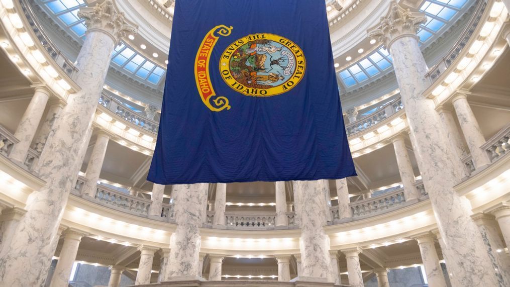 FILE - The Idaho state flag hangs in the State Capitol in Boise, Idaho, Jan. 9, 2023. Republicans in Idaho and Missouri will have to attend caucuses to cast their presidential picks in 2024, after GOP-led legislatures in those states canceled their presidential primaries and then missed a deadline to reinstate them. Presidential caucuses in both states are planned on March 2, 2024. (AP Photo/Kyle Green, File)