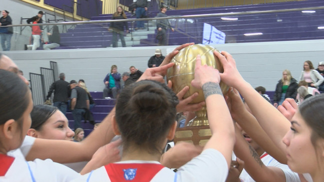 Teammates gather around the trophy one last time.{&nbsp;}{p}{/p}