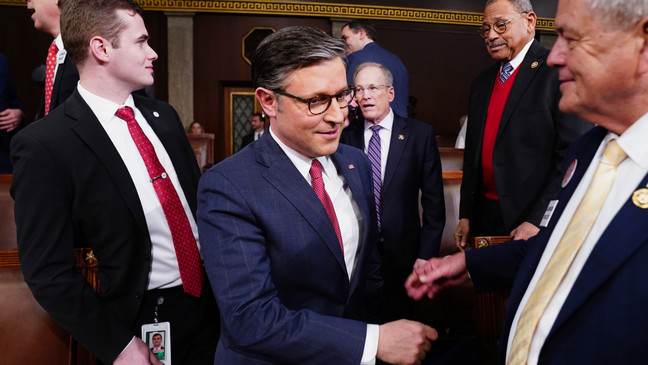 Speaker of the House Mike Johnson, R-La., center, arrives before President Joe Biden delivers the State of the Union address to a joint session of Congress at the Capitol, Thursday, March 7, 2024, in Washington. (Shawn Thew/Pool via AP)