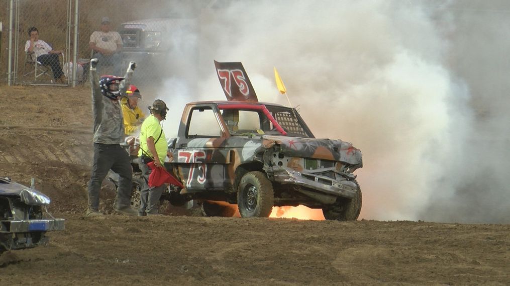 A driver gets out of his car after it catches on fire at the smash bash demolition derby.{&nbsp;}{p}{/p}