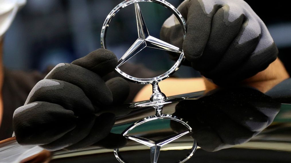 FILE - In this Thursday, April 30, 2020 file photo, an employee attaches a Mercedes emblem as he works on a Mercedes-Benz S-class car at the Mercedes plant in Sindelfingen, Germany.{&nbsp;} (AP Photo/Matthias Schrader, file)