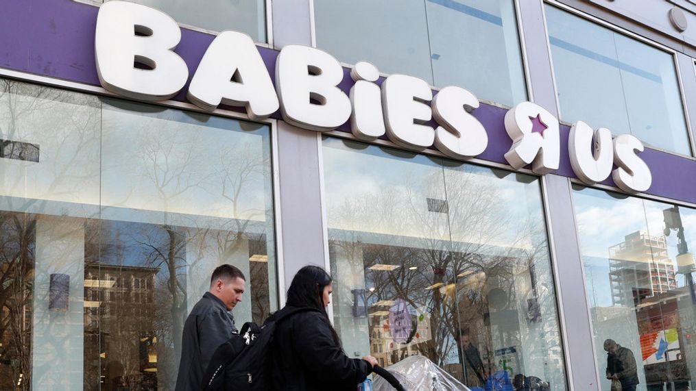 FILE - Queens residents Carlos Lopes, left, and Katiria Maldonado and their young child leave Babies R Us after shopping at Manhattan's Union Square store in New York, Wednesday, Jan. 24, 2018. (AP Photo/Kathy Willens)